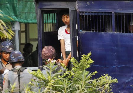 A student protester exits a prison vehicle, as he is sent to a court in Letpadan March 11, 2015. REUTERS/Soe Zeya Tun