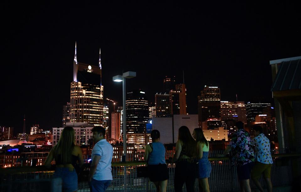 Fans take a break from performances with the Nashville skyline CMA Fest at Nissan Stadium in Nashville, Tenn., Friday, June 7, 2024.