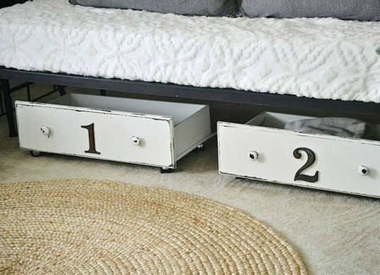 <p>These repurposed drawers make use of the empty space under the <a href="http://www.bobvila.com/slideshow/9-inventive-ways-to-build-an-extra-bed-48341" rel="nofollow noopener" target="_blank" data-ylk="slk:bed;elm:context_link;itc:0;sec:content-canvas" class="link ">bed</a> without sacrificing style. Get the look by painting unused dresser or cabinet drawers, then adorning the drawer faces with metallic numerals. After affixing wheels to the base of the drawers, fill them with off-season clothes or extra bedding, and then roll them out of the way. <i>Photo: <a href="http://www.lizmarieblog.com/2014/03/diy-under-the-bed-storage/" rel="nofollow noopener" target="_blank" data-ylk="slk:lizmarieblog.com;elm:context_link;itc:0;sec:content-canvas" class="link ">lizmarieblog.com</a><br></i><b>RELATED: <a href="http://www.bobvila.com/slideshow/underbed-storage-8-helpers-to-buy-or-diy-48130" rel="nofollow noopener" target="_blank" data-ylk="slk:Underbed Storage—8 Helpers to Buy or DIY;elm:context_link;itc:0;sec:content-canvas" class="link ">Underbed Storage—8 Helpers to Buy or DIY</a></b></p>