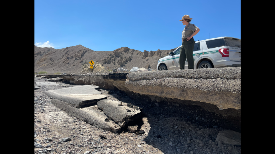 A ranger surveys the damage done by flooding caused by the “remnants of Hurricane Hilary.”