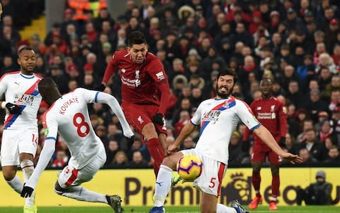 Liverpool's Brazilian midfielder Roberto Firmino (C) shoots to score their second goal during the English Premier League football match between Liverpool and Crystal Palace at Anfield in Liverpool, north west England on January 19, 2019. (Photo by Paul ELLIS / AFP) / RESTRICTED TO EDITORIAL USE. No use with unauthorized audio, video, data, fixture lists, club/league logos or 'live' services. Online in-match use limited to 120 images. An additional 40 images may be used in extra time. No video emulation. Social media in-match use limited to 120 images. An additional 40 images may be used in extra time. No use in betting publications, games or single club/league/player publications - Credit: AFP