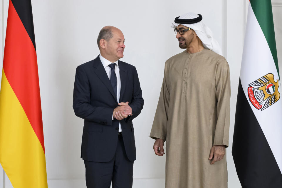 In this photo made available by the United Arab Emirates Presidential Court, Sheikh Mohamed bin Zayed Al Nahyan, President of the UAE right, and German Chancellor Olaf Scholz, talk prior to a meeting at Al Shati Palace in Abu Dhabi, United Arab Emirates, Sunday, Sept. 25, 2022. (Abdulla Al Neyadi/UAE Presidential Court via AP)