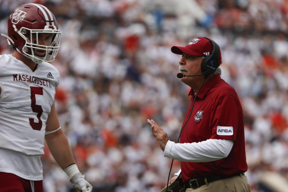 Massachusetts head coach Don Brown talks with linebacker Tyler Martin (5) as he walks off the field during the first half of an NCAA college football game against Auburn Saturday, Sept. 2, 2023, in Auburn, Ala. (AP Photo/Butch Dill)