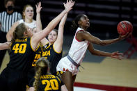 Maryland guard Diamond Miller, right, goes up for a shot against Iowa center Sharon Goodman (40), guard Kate Martin (20) and guard Lauren Jensen, center, during the second half of an NCAA college basketball game, Tuesday, Feb. 23, 2021, in College Park, Md. Maryland won 111-93. (AP Photo/Julio Cortez)