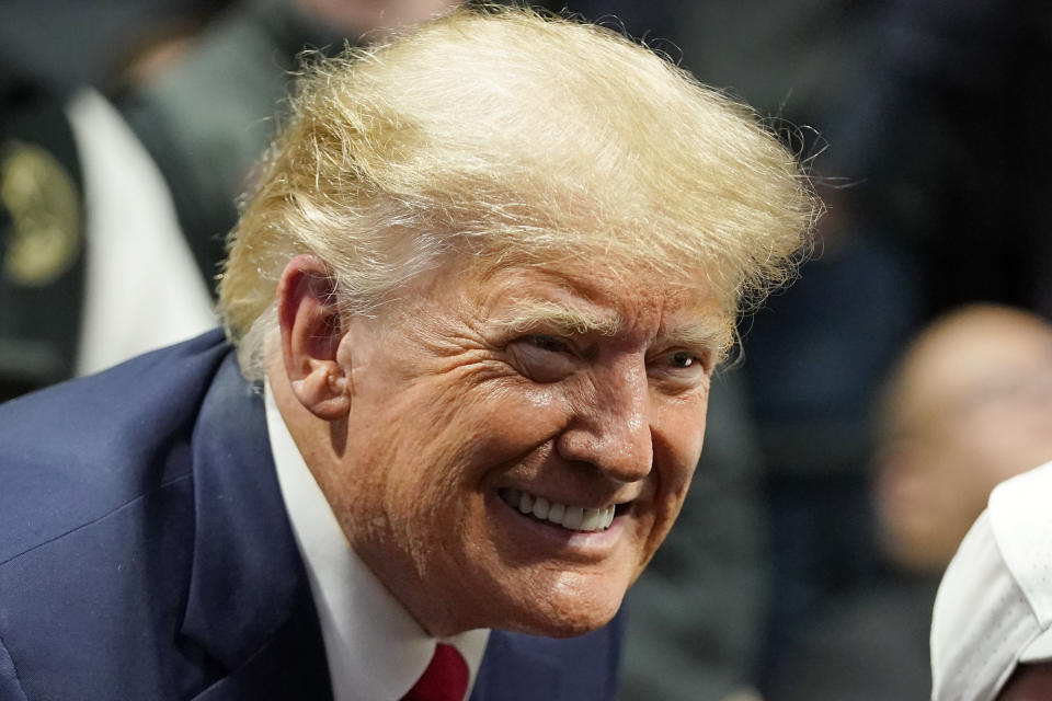 Former President Donald J. Trump smiles as he poses for a photo at the NCAA Wrestling Championships, Saturday, March 18, 2023, in Tulsa, Okla. (AP Photo/Sue Ogrocki)