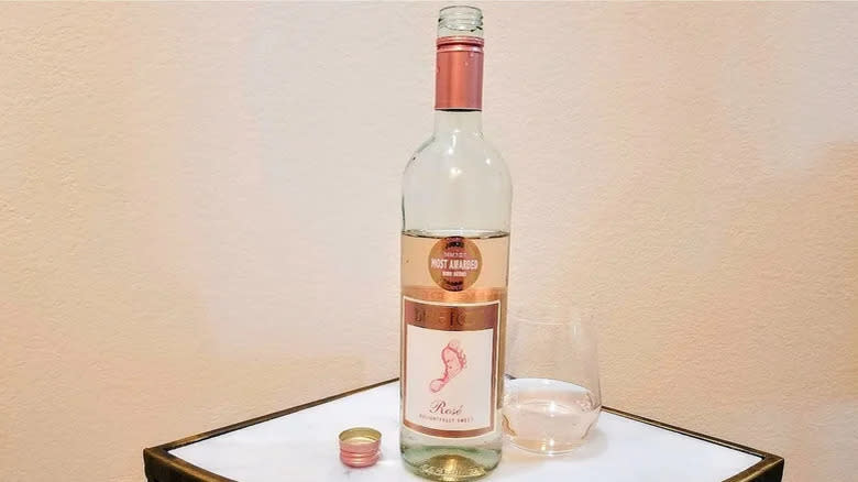 glass and bottle of barefoot rose wine