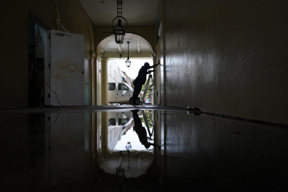 In preparation of Hurricane Ida, a worker attaches protective plywood to windows and doors of a business in the French Quarter in New Orleans, Saturday, Aug. 28, 2021. (AP Photo/Eric Gay)