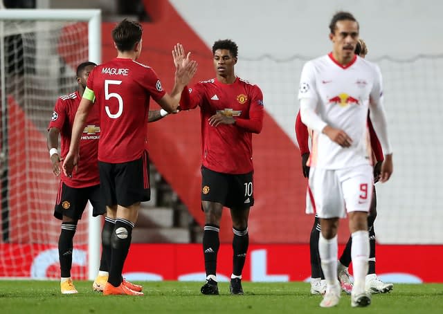 Harry Maguire celebrates with Marcus Rashford against RB Leipzig