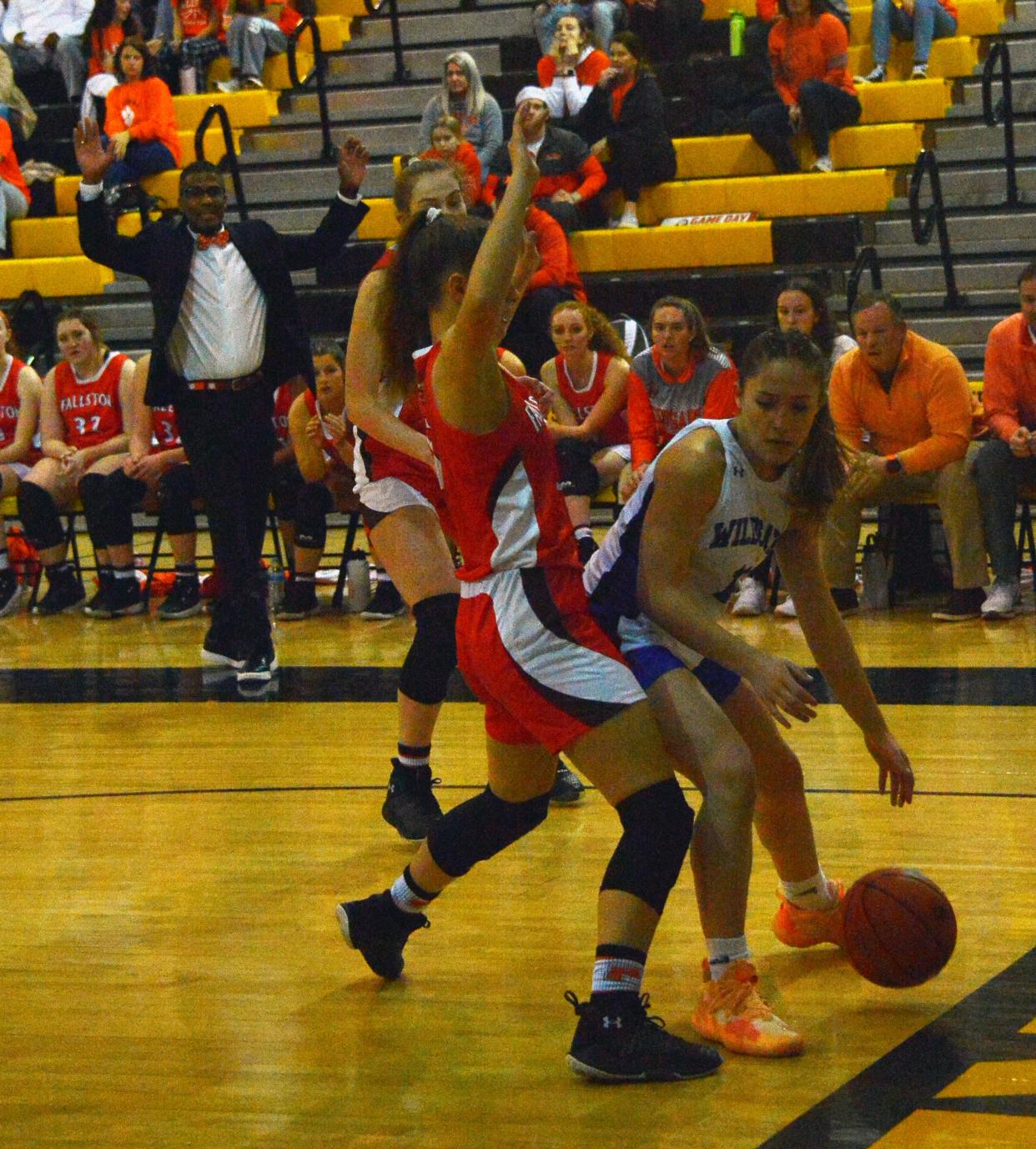 Williamsport's Ellie Levasseur tries to find room to move along the baseline while Fallston's Allie Book eliminates some options.