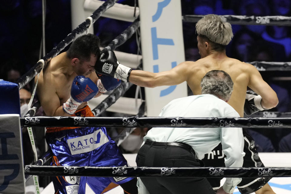 Japan's Naoya Inoue hits Philippines' Nonito Donaire in their bantamweight title unification boxing match of WBA, WBC and IBF in Saitama, north of Tokyo, Tuesday, June 7, 2022. (AP Photo/Hiro Komae)