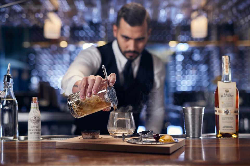 Fancy a classic cocktail? Eddie V's smoked old fashion is made with Basil Hayden's Bourbon, a dash of chocolate bitters and served on a smoked plank tableside.