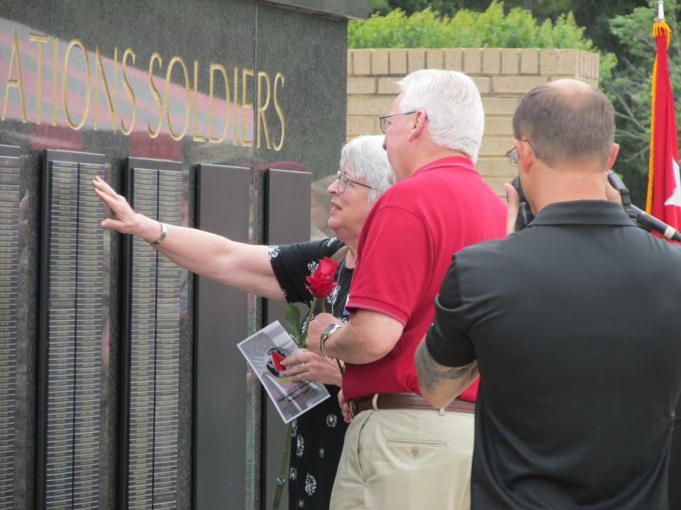 Gold Star family members scan the U.S. Army Special Operations Command Memorial Wall after a ceremony Thursday, May 25, 2023, at Fort Bragg.