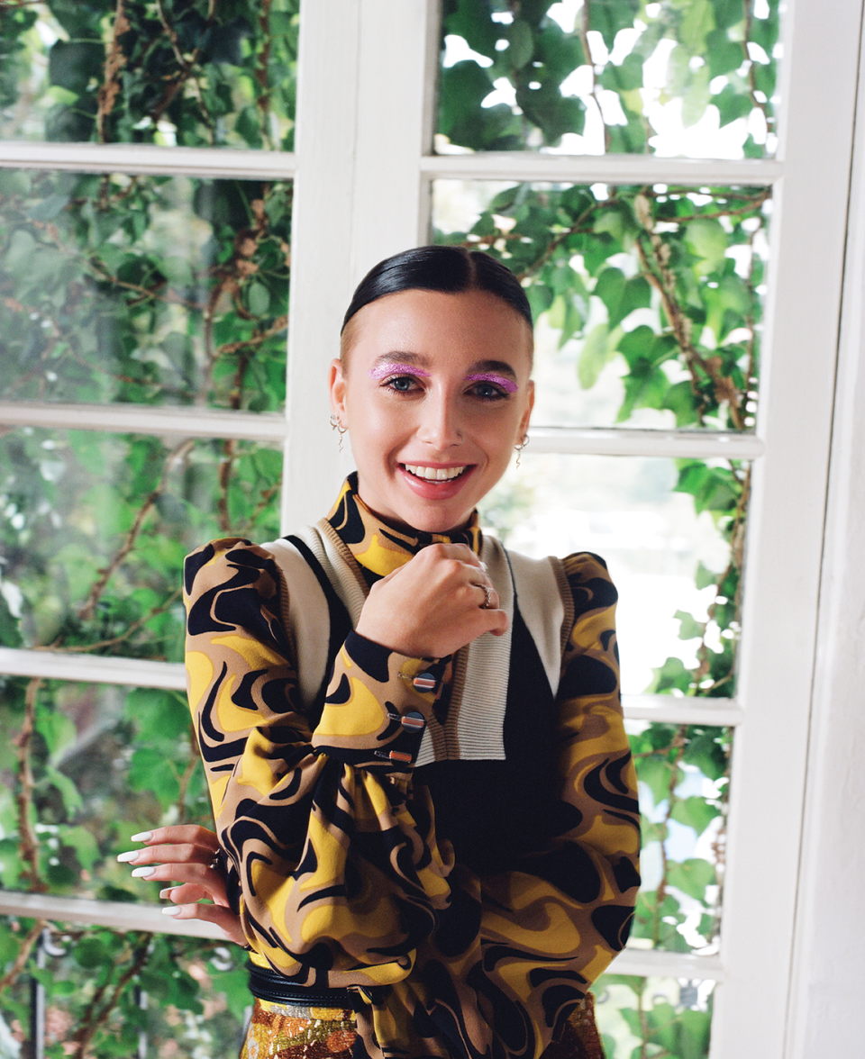 Louis Vuitton blouse, vest, and skirt. Chamberlain’s own jewelry. Makeup colors: The City Kits Eye + Cheek Palette in Urban Light, The Falsies Lash Lift Mascara in Blackest Black, and Lifter Gloss in Silk by Maybelline New York.