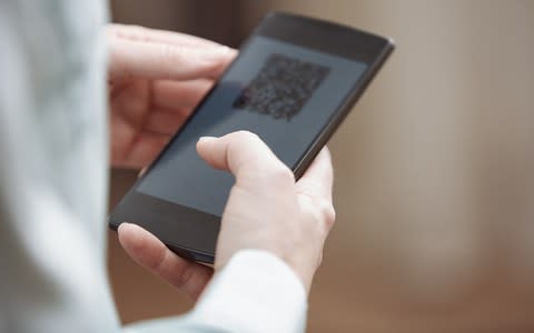 QR code technology has enabled us to scan boarding passes ourselves - Credit: Getty