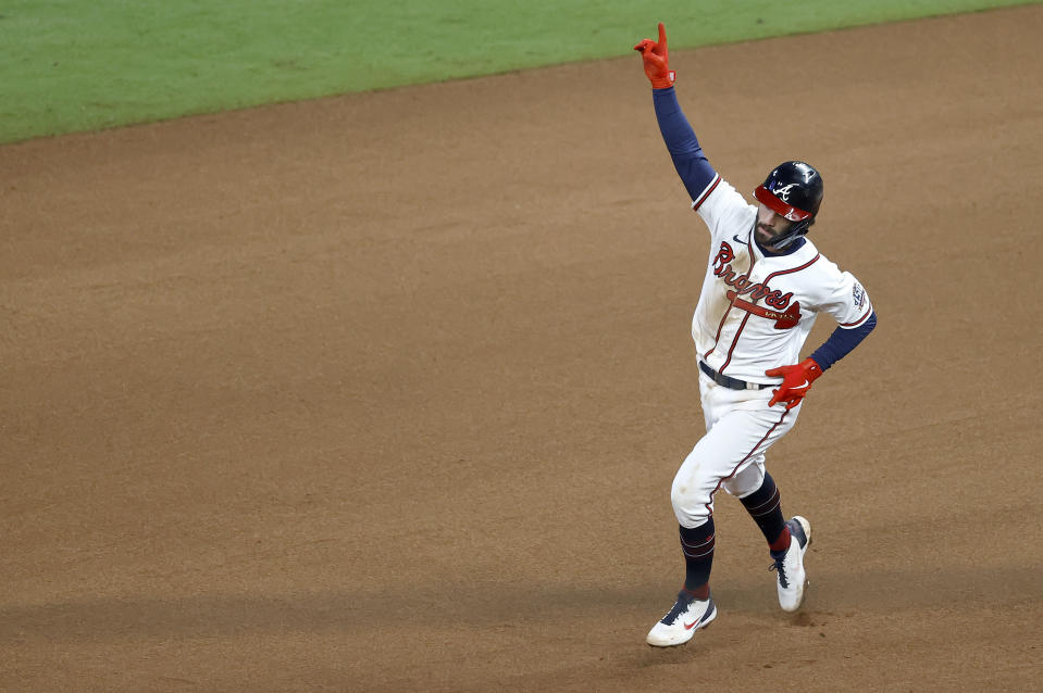 Dansby Swanson celebrates a game-tying home run. (Michael Zarrilli/Getty Images)