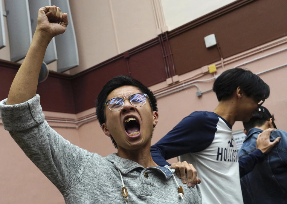 Supporters of a pro-democracy candidate cheer after winning their seat in district council elections in Hong Kong, early Monday, Nov. 25, 2019. Voters in Hong Kong turned out in droves on Sunday in district council elections seen as a barometer of public support for pro-democracy protests that have rocked the semi-autonomous Chinese territory for more than five months. (AP Photo/Vincent Yu)