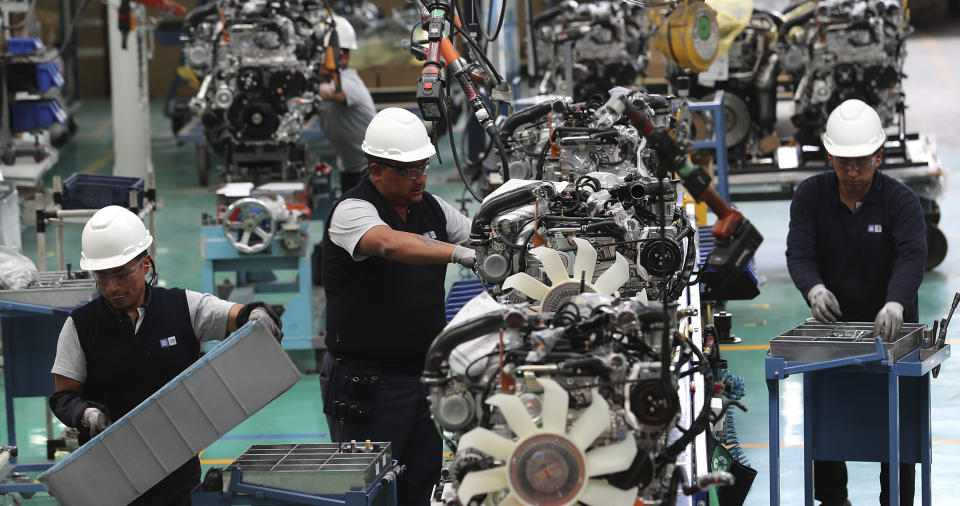 Workers assemble cars at the General Motors plant in Quito, Ecuador, Tuesday, Oct. 15, 2019. The recent national strike has left President Lenin Moreno and his administration struggling to figure out how stabilize the budget, reassure international lenders and put Ecuador put on a path of economic sustainability. (AP Photo/Dolores Ochoa)