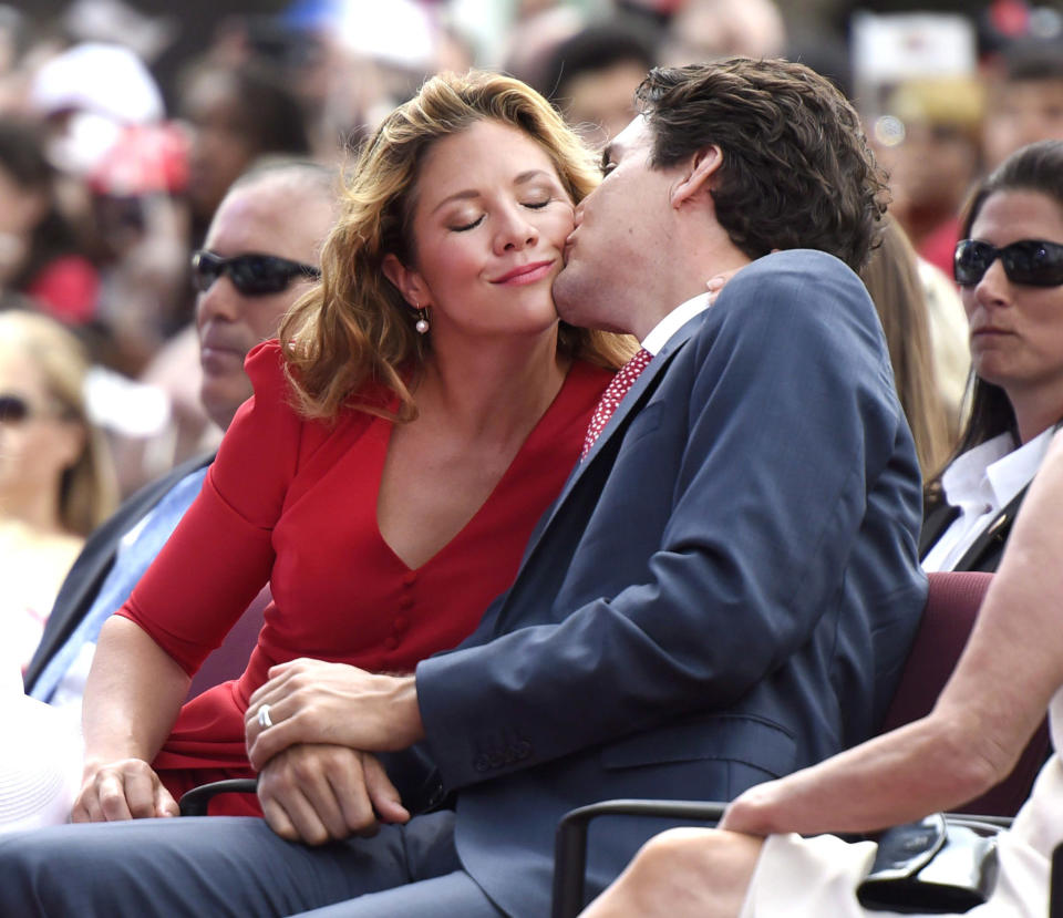 <p>Kissing his wife on the cheek during the Canada Day noon hour entertainment</p>