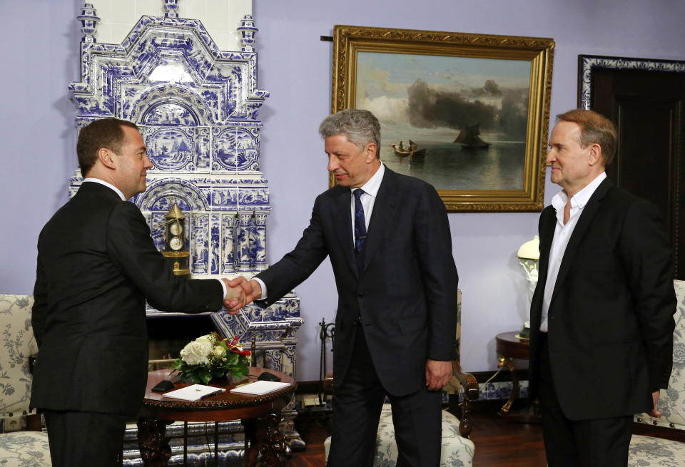 Russian Prime Minister Dmitry Medvedev, left, shakes hands with Ukrainian presidential candidate Yuri Boyko, center, as Ukrainian politician Viktor Medvedchuk, right, attends their meeting in Moscow, Russia, Friday, March 22, 2019. A Ukrainian presidential candidate has traveled to Moscow to meet with the Russian prime minister to discuss gas supplies. (Yekaterina Shtukina, Sputnik, Government Pool Photo via AP)