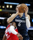 Dallas Mavericks forward Kristaps Porzingis (6) attempts a shot as Sacramento Kings guard Buddy Hield (24) defends during the first half of an NBA basketball game, Wednesday, Feb. 12, 2020, in Dallas. (AP Photo/Brandon Wade)