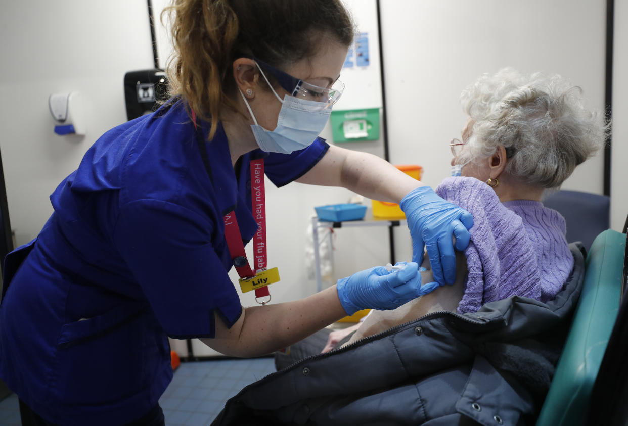 A nurse administers the Pfizer-BioNTech COVID-19 vaccine at Guy&#39;s Hospital in London, Tuesday, Dec. 8, 2020. U.K. health authorities rolled out the first doses of a widely tested and independently reviewed COVID-19 vaccine Tuesday, starting a global immunization program that is expected to gain momentum as more serums win approval. (AP Photo/Frank Augstein, Pool)