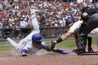 Los Angeles Dodgers' Joey Gallo, left, is tagged out at home by San Francisco Giants catcher Austin Wynns during the fourth inning of a baseball game in San Francisco, Thursday, Aug. 4, 2022. (AP Photo/Jeff Chiu)