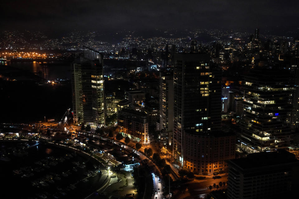 Beirut and suburbs are lit by privately-owned diesel generators that provide power to homes and businesses during a blackout, Lebanon, Oct. 10, 2021. Private generators are ubiquitous in parts of the Middle East, spewing hazardous fumes into homes and business across the country, almost 24 hours a day. As the world looks for renewable energy to tackle climate change, Lebanon, Iraq, Gaza and elsewhere rely on diesel-powered private generators just to keep the lights on. The reason is state failure: In multiple countries, governments can’t maintain a functioning central power network, whether because of war, conflict or mismanagement and corruption. (AP Photo/Hassan Ammar)