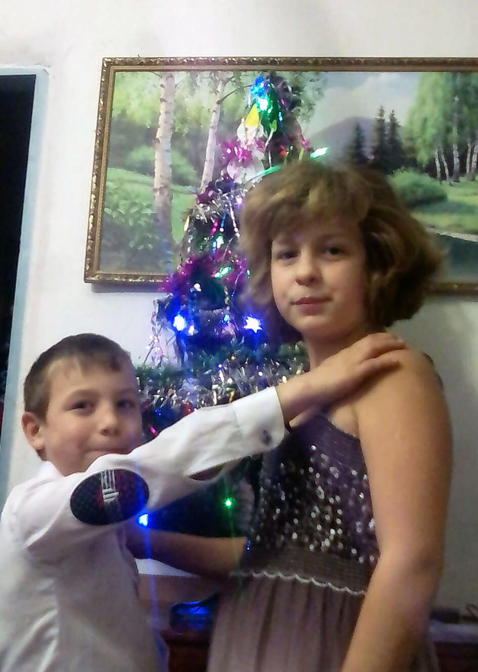 The brother and sister in front of a Christmas tree. Source: East2West/Australscope