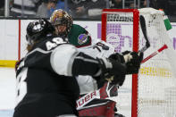 Los Angeles Kings forward Brendan Lemieux, front, scores on Arizona Coyotes goalie Karel Vejmelka during the second period of an NHL hockey game Sunday, Nov. 21, 2021, in Los Angeles. (AP Photo/Ringo H.W. Chiu)