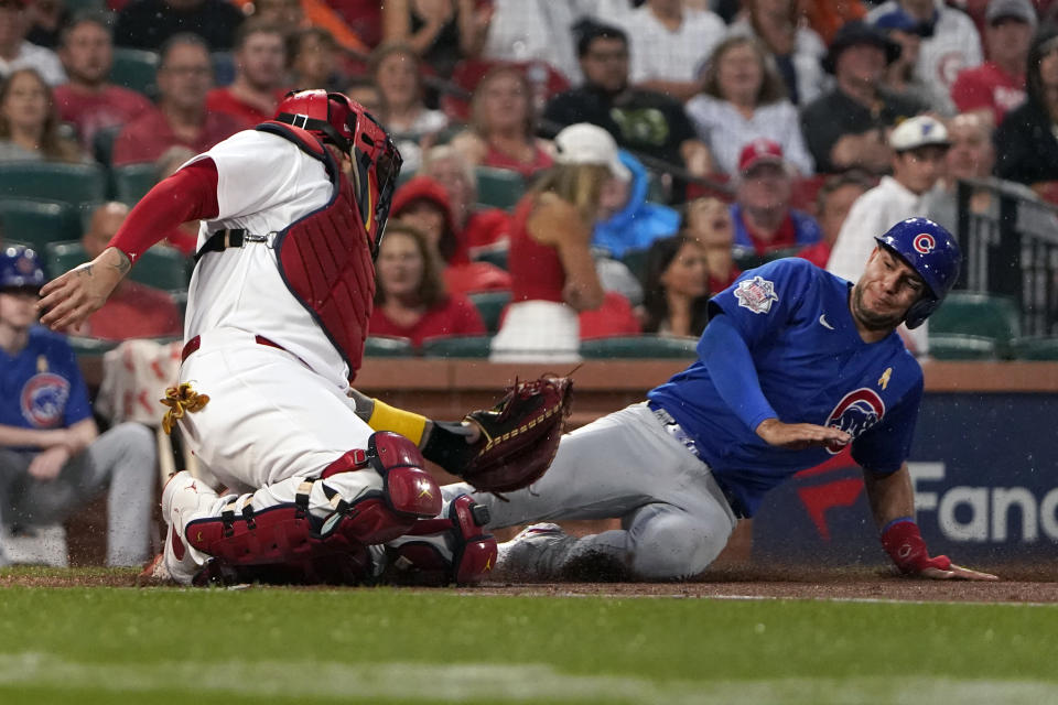 Chicago Cubs' Nick Madrigal, right, is tagged out at home by St. Louis Cardinals catcher Yadier Molina during the first inning of a baseball game Friday, Sept. 2, 2022, in St. Louis. (AP Photo/Jeff Roberson)