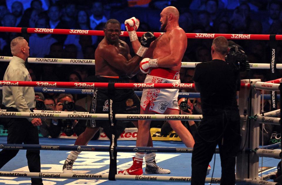 Britain's Tyson Fury (R) lands a punch to knockout Britain's Dillian Whyte in the sixth round and win their WBC heavyweight title fight at Wembley Stadium in west London, on April 23, 2022. - Tyson Fury stopped British rival Dillian Whyte in the sixth round to retain his WBC heavyweight crown at a packed Wembley on Saturday. In his first fight on UK soil in four years, Fury was treated to a hero's welcome by a 94,000-capacity crowd and largely dictated the tempo before ending proceedings in devastating fashion. (Photo by Adrian DENNIS / AFP) (Photo by ADRIAN DENNIS/AFP via Getty Images)