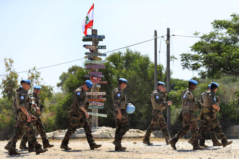 French U.N. peacekeepers walk on a road that leads to a United Nations Interim Force In Lebanon position, in the southern coastal border Lebanese-Israeli town of Naqoura, Lebanon, Monday, June 6, 2022. The Lebanese government invited on Monday a U.S. envoy mediating between Lebanon and Israel over their disputed maritime border to return to Beirut as soon as possible to work out an agreement amid rising tensions along the border. (AP Photo/Mohammed Zaatari)