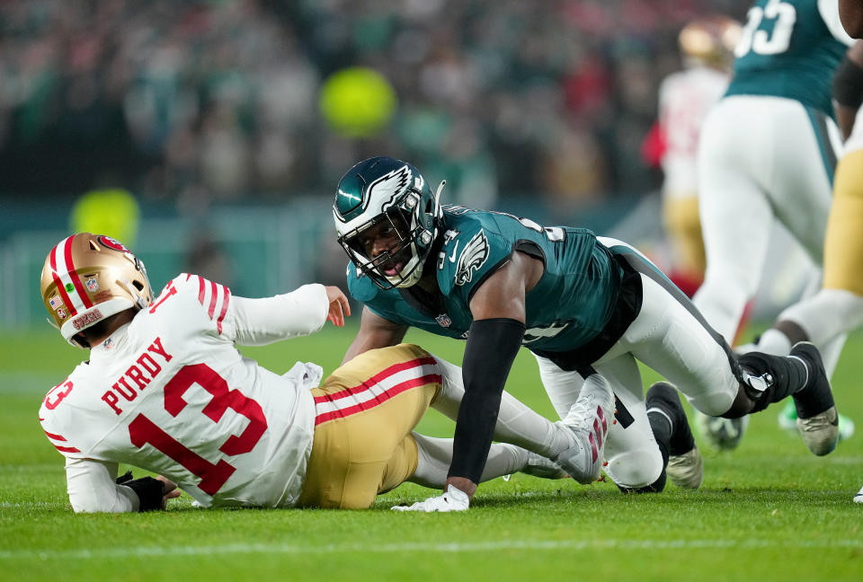 PHILADELPHIA, PENNSYLVANIA – DECEMBER 03: Josh Sweat #94 of the Philadelphia Eagles knocks down Brock Purdy #13 of the San Francisco 49ers during the first quarter at Lincoln Financial Field on December 03, 2023 in Philadelphia, Pennsylvania. (Photo by Mitchell Leff/Getty Images)