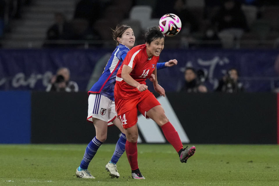 North Korea's Hong Song Ok, front, and Japan's Hikaru Kitagawa compete for the ball during the final qualifier for the Paris Olympic women's football tournament at the National Stadium Wednesday, Feb. 28, 2024, in Tokyo. (AP Photo/Eugene Hoshiko)