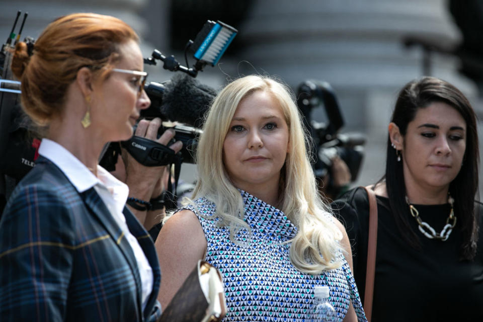 Virginia Giuffre, an alleged victim of Jeffrey Epstein, center, exits from federal court in New York, U.S., on Tuesday, Aug. 27, 2019. | Jeenah Moon—Bloomberg via Getty Images