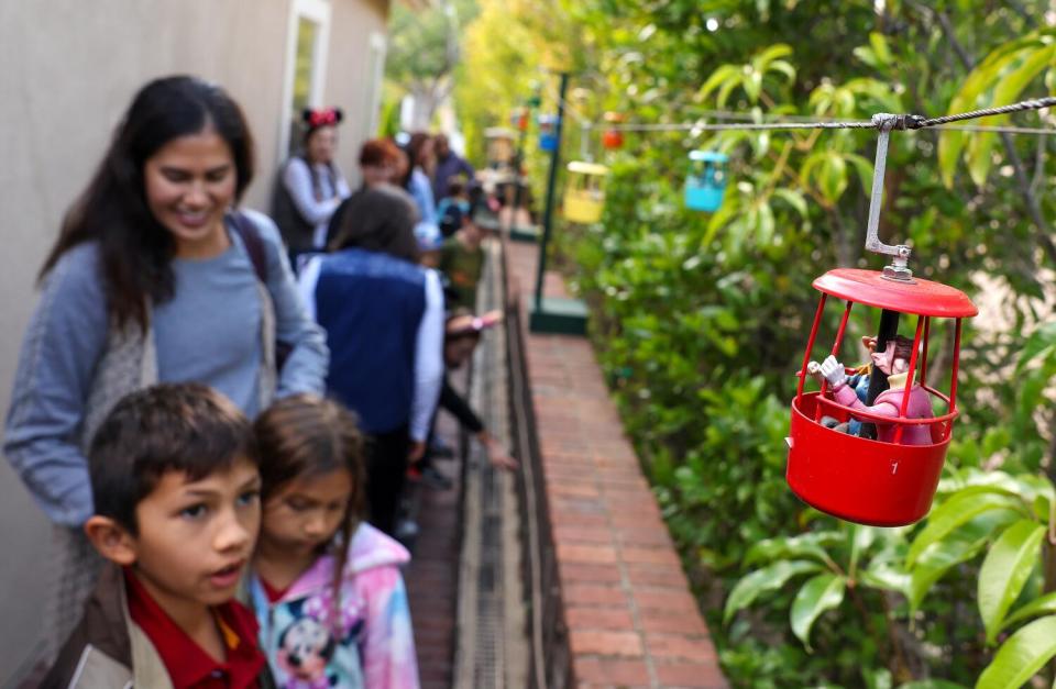 Fans walk in the backyard of a home in Anaheim Hills that has a Disneyland theme.