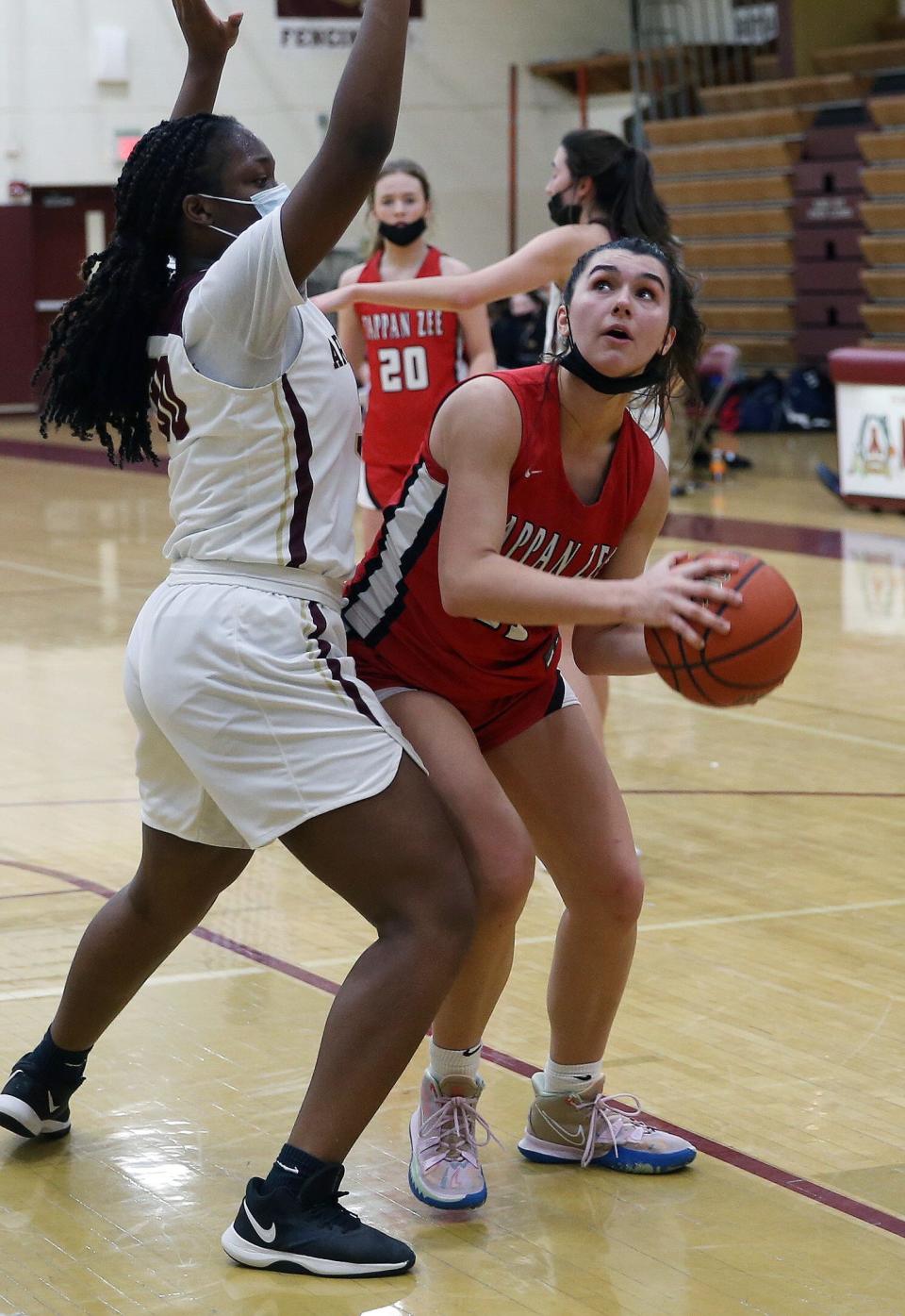 Tappan Zee's Arianna Kupi (11) goes up for a shot in front of Arlington's Nneoma Ezeilo (30) during girls basketball action at Arlington High School in Freedom Plains Jan. 26, 2022. Tappan Zee won the game 57-47.