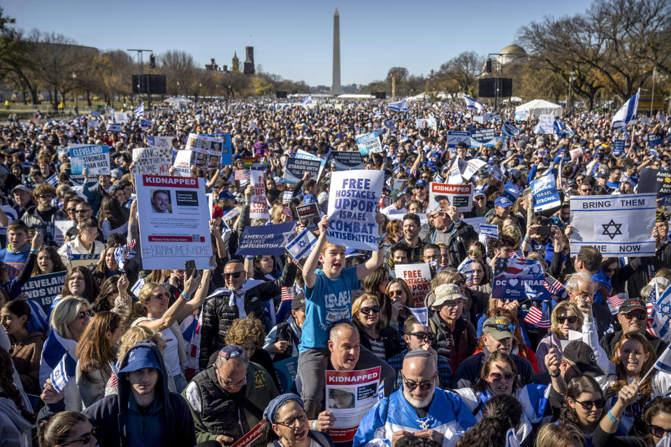 Image: Participants hold signs as they stand on the National Mall at the March for Israel (Mark Schiefelbein / AP)