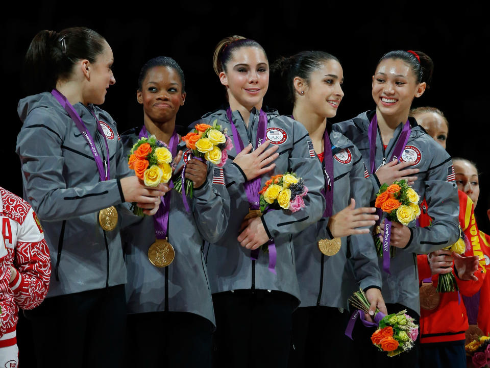 Jordyn Wieber, Gabrielle Douglas, Mc Kayla Maroney, Alexandra Raisman and Kyla Ross of the United States celebrate on the podium after winning the gold medal in the Artistic Gymnastics Women's Team final on Day 4 of the London 2012 Olympic Games at North Greenwich Arena on July 31, 2012 in London, England. (Photo by Jamie Squire/Getty Images)