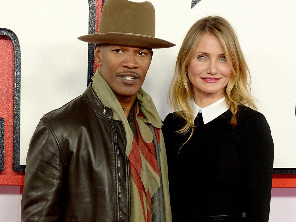 Jamie Foxx in a hat and jacket standing next to Cameron Diaz in a black sweater