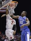 Louisville's Russ Smith (2) dunks over Kentucky's Julius Randle (30) during the first half of an NCAA Midwest Regional semifinal college basketball tournament game Friday, March 28, 2014, in Indianapolis. (AP Photo/David J. Phillip)