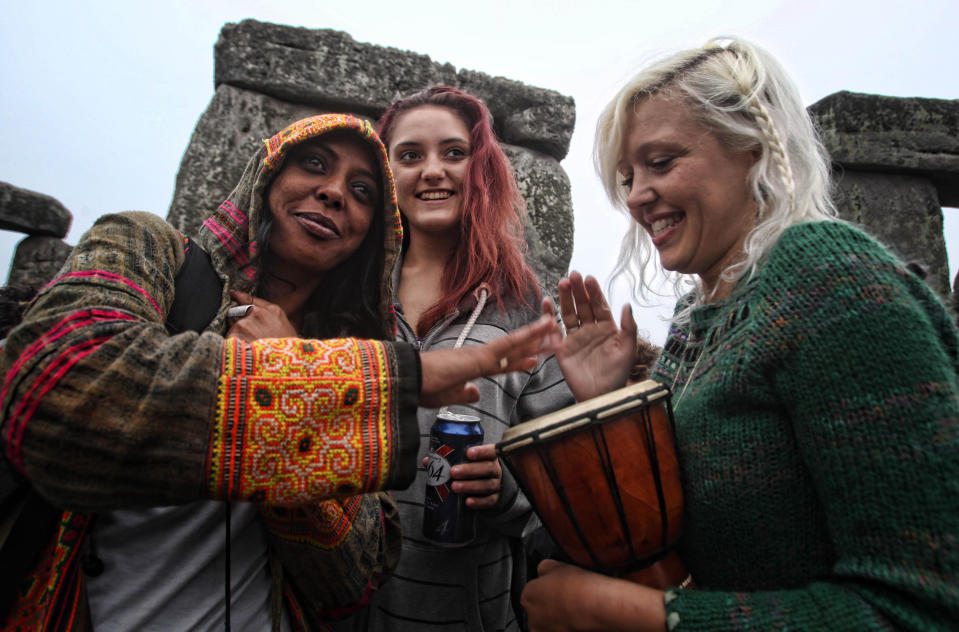 Crowds gather at dawn amongst the stones at Stonehenge in Wiltshire for the Summer Solstice.