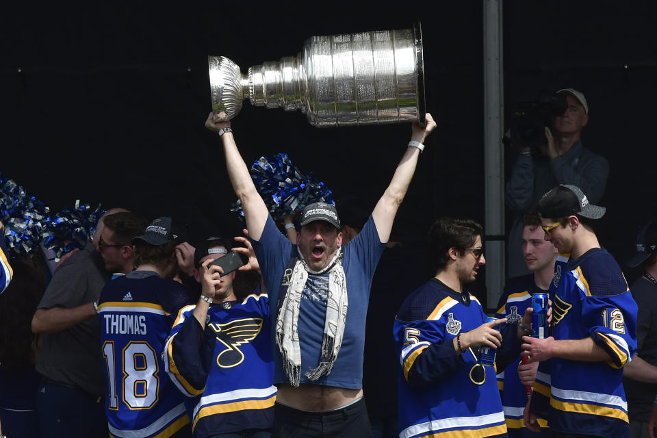 Jun 15, 2019; St. Louis, MO, USA; St. Louis Blues fan and actor Jon Hamm hoists the Stanley Cup during the Stanley Cup championship parade and rally at the Gateway Arch. Mandatory Credit: Jeff Curry-USA TODAY Sports