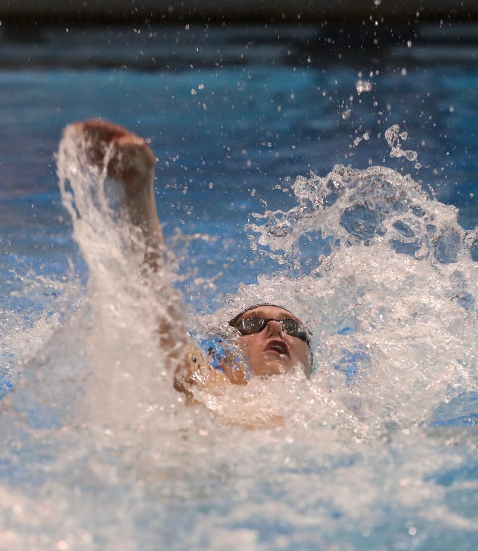 St. Xavier's Johnny Crush races and wins the 100 backstroke Friday at the KHSAA State Championships in Lexington.