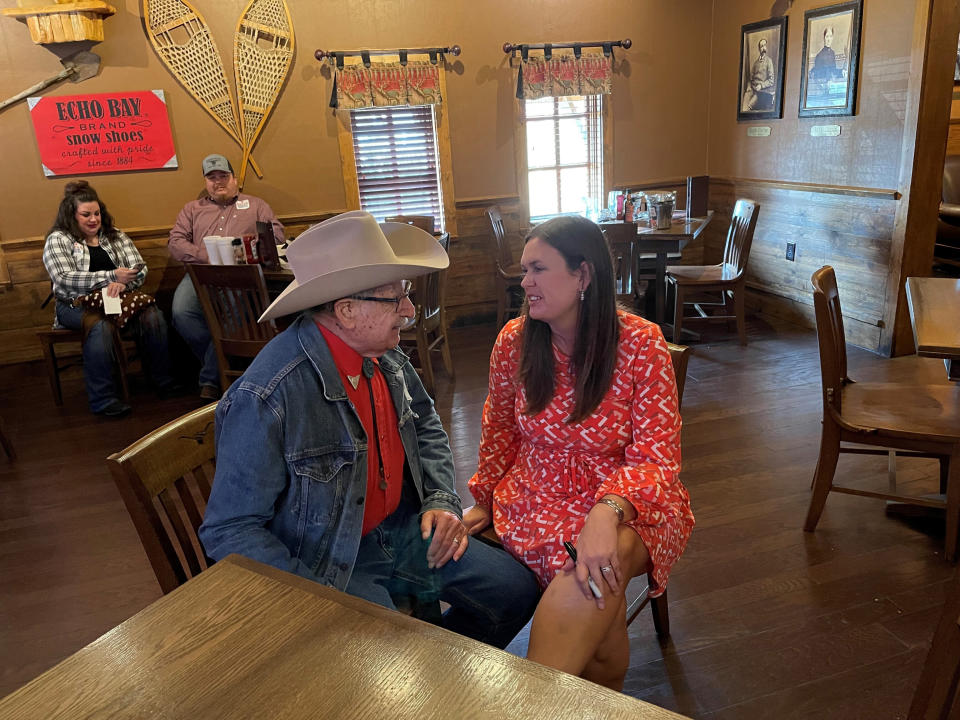 Former White House Press Secretary Sarah Sanders talks to Harold Glenn Earnest while campaigning at a Colton's Steak House in Cabot, Ark., Friday, Sept. 10, 2021. Sanders is running for the Republican nomination for governor in Arkansas. (AP Photo/Andrew DeMillo)