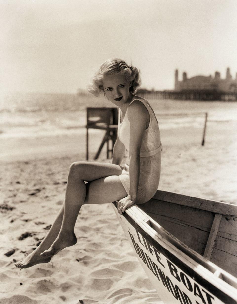 <p>Although Bette Davis's boat is landlocked, the star still looks like a natural, as she poses on the bow in a one-piece bathing suit. </p>