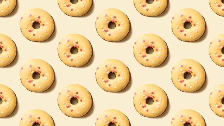 yellow iced donuts with sprinkles