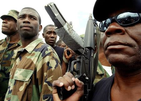 Guy Philippe, former police chief police, participates in a march into the city of Gonaives, Haiti, February 19, 2004. REUTERS/Daniel Aguilar/Files