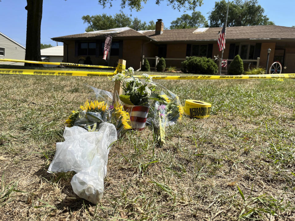 FILE - A small memorial sits outside the home of Gene Twiford, 86, Janet Twiford, 85, and Dana Twiford, 55, Aug. 5, 2022, in Laurel, Neb. The three were among four people found dead the day before in two burning homes in this small community in northeastern Nebraska, authorities said. On Thursday, March 30, 2023, a Nebraska judge rejected a challenge to the death penalty in the case of a man charged in the killings of four people last summer in the small town of Laurel in the northeastern corner of the state. (AP Photo/Margery A. Beck, File)