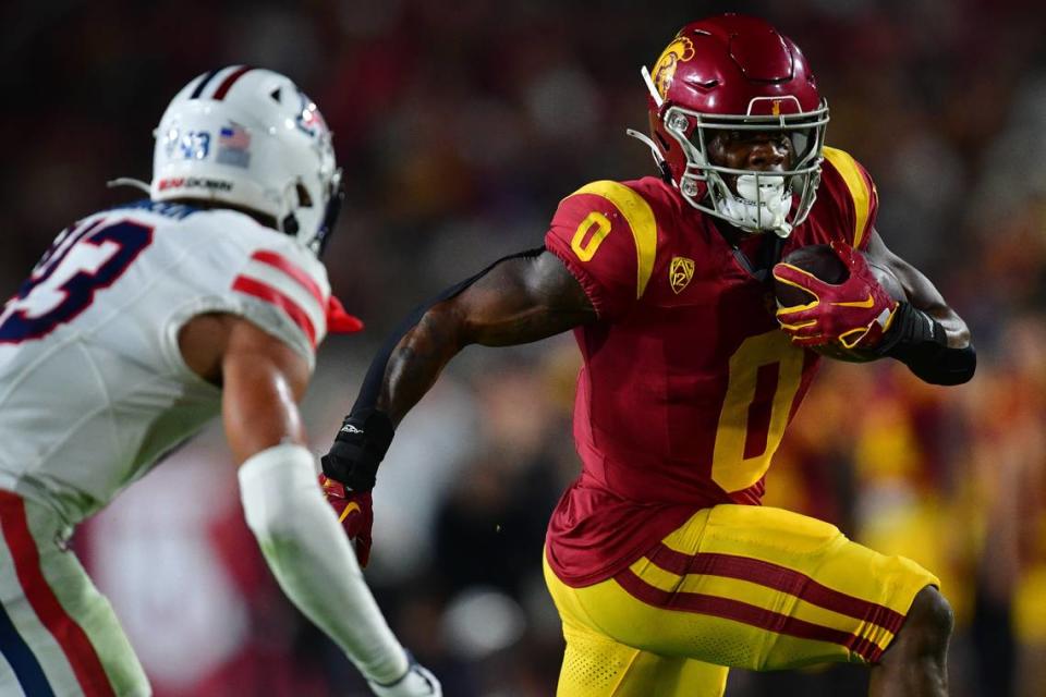 Oct 7, 2023; Los Angeles, California, USA; Southern California Trojans running back MarShawn Lloyd (0) runs the ball against Arizona Wildcats safety Dalton Johnson (43) during the second half at Los Angeles Memorial Coliseum. Mandatory Credit: Gary A. Vasquez-USA TODAY Sports Gary A. Vasquez/Gary A. Vasquez-USA TODAY Sports